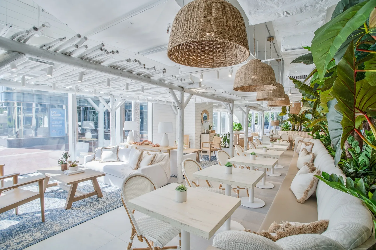 bright coastal restaurant with woven pendant lights and lush greenery throughout., cafe club, miami
