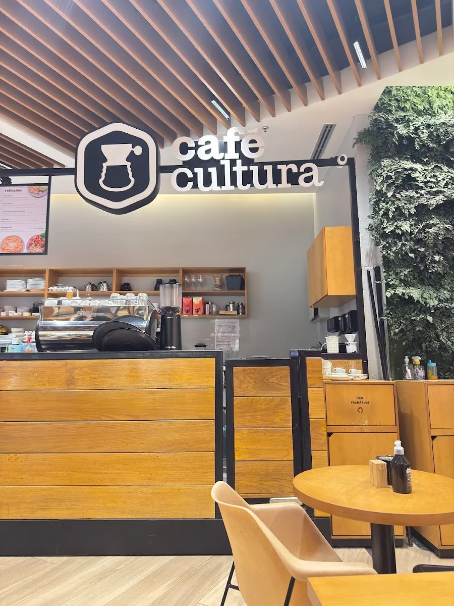 modern café interior with wooden counter, coffee equipment, and green plant wall., café cultura, rio de janeiro
