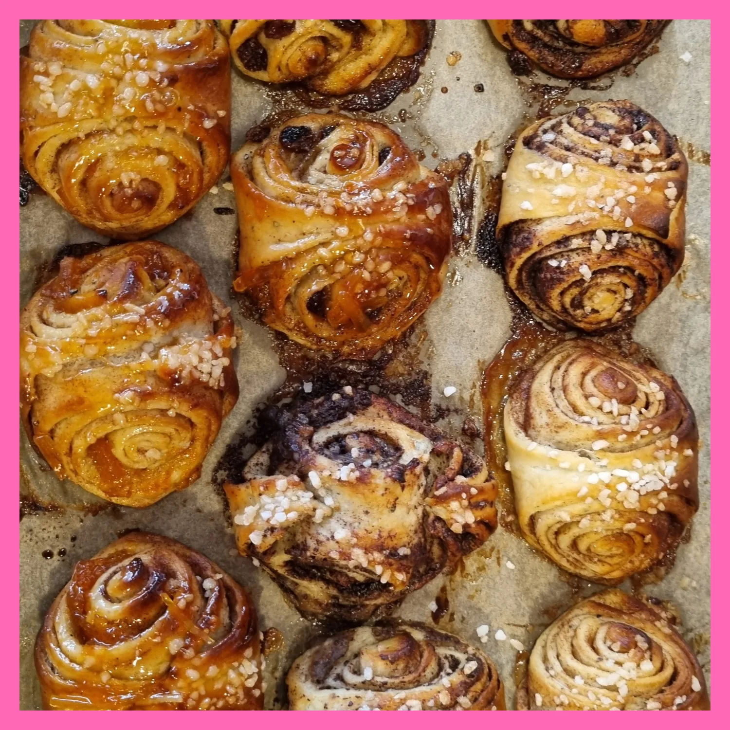 freshly baked cinnamon rolls with pearl sugar on parchment paper., cafe flemari20, helsinki