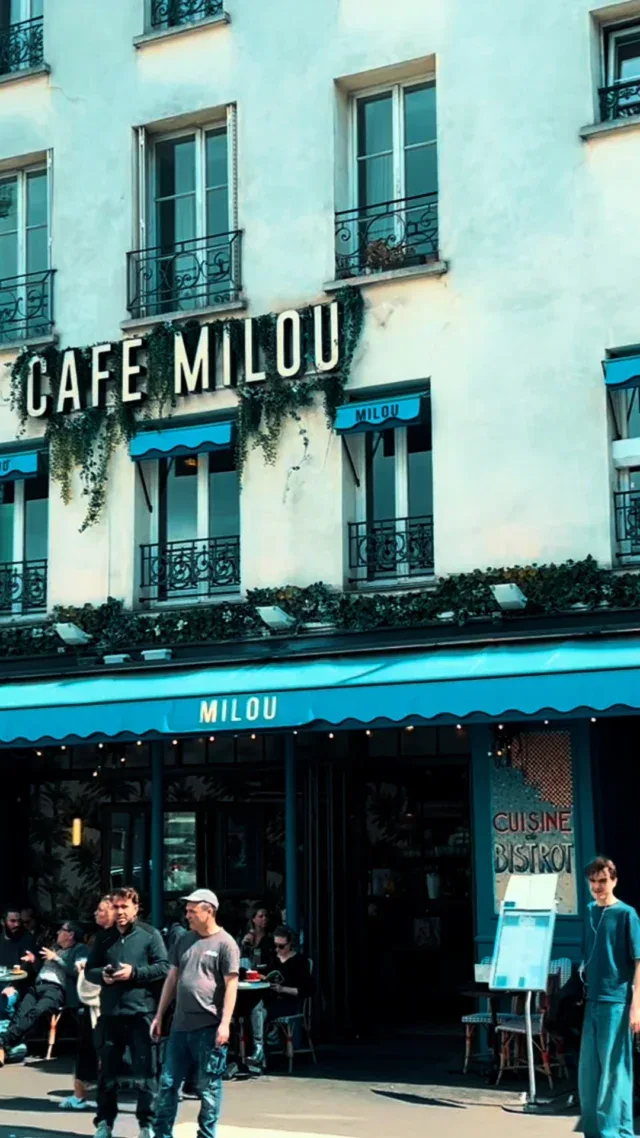 cafe milou storefront with blue awning, parisian architecture, and outdoor diners., café milou bastille, paris