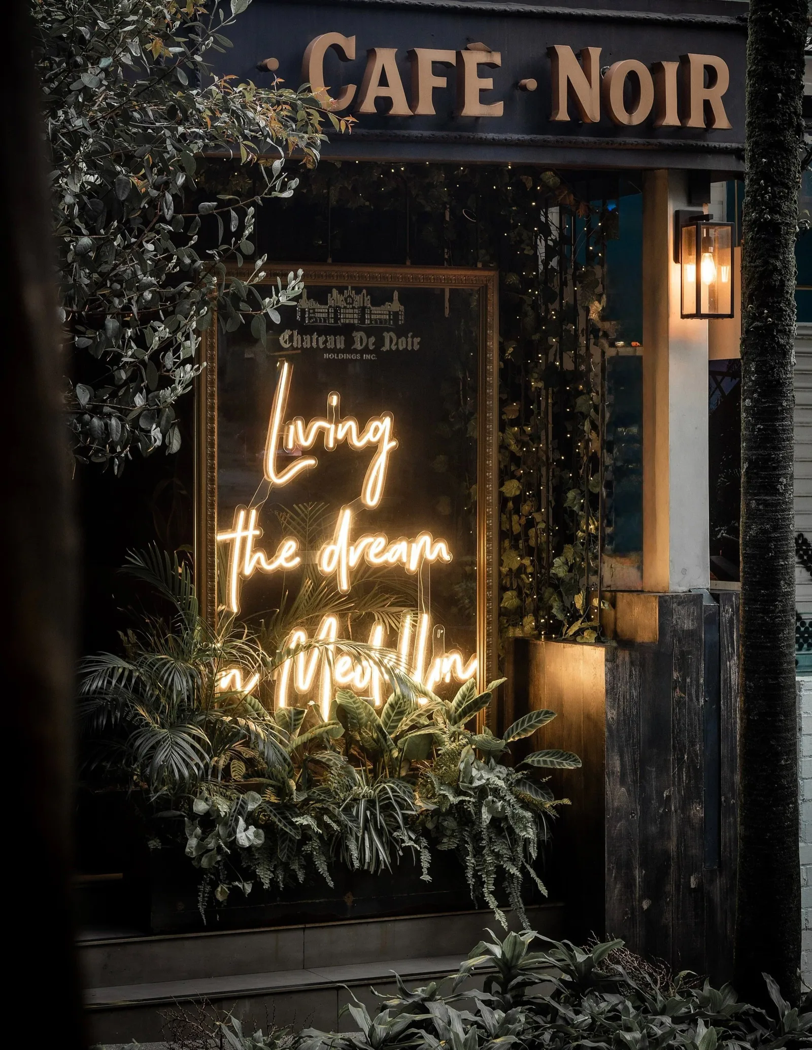 café noir storefront with neon sign reading "living the dream in style", café noir bar & lounge, medellín