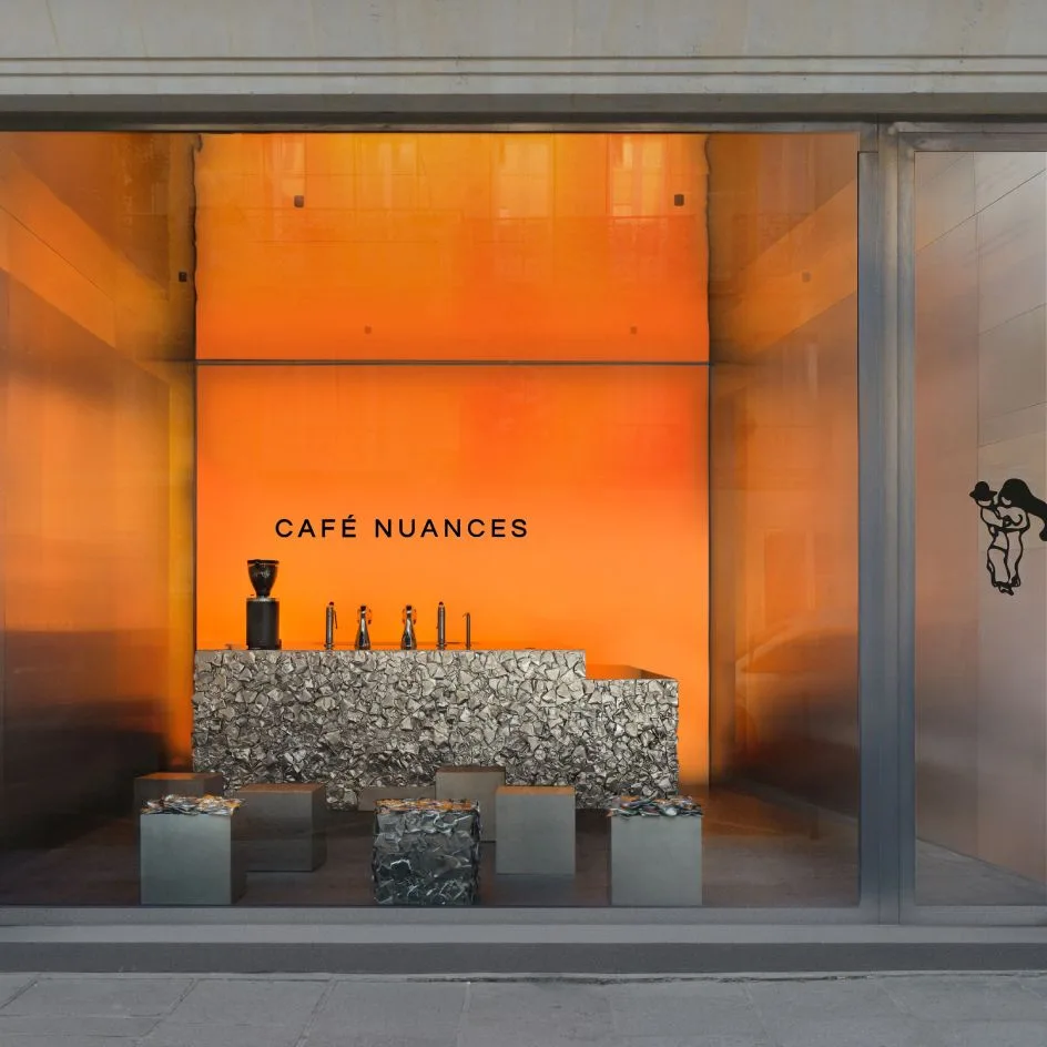 vibrant orange storefront display for café nuances with minimalist seating arrangement., café nuances - vendôme, paris