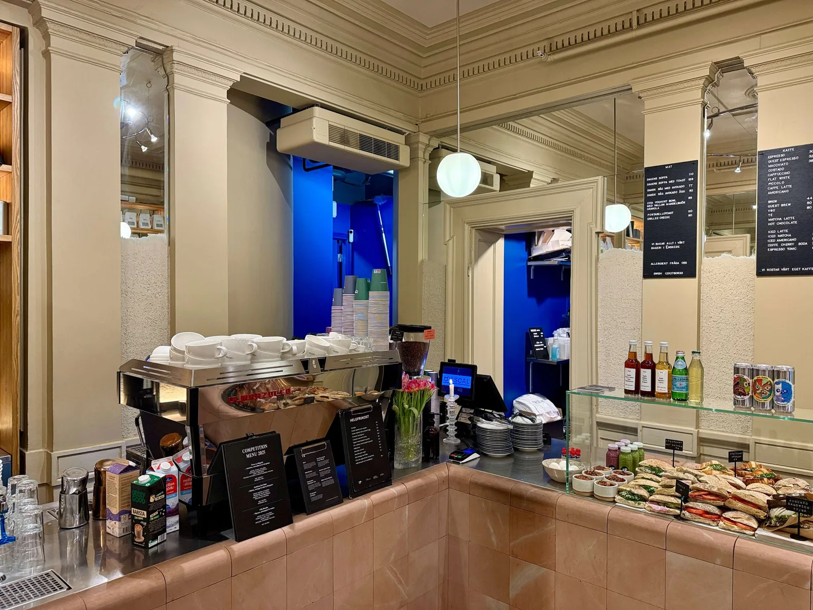 modern café counter with pastries, beverages, and elegant cream and blue décor., café pascal - södermalm, stockholm