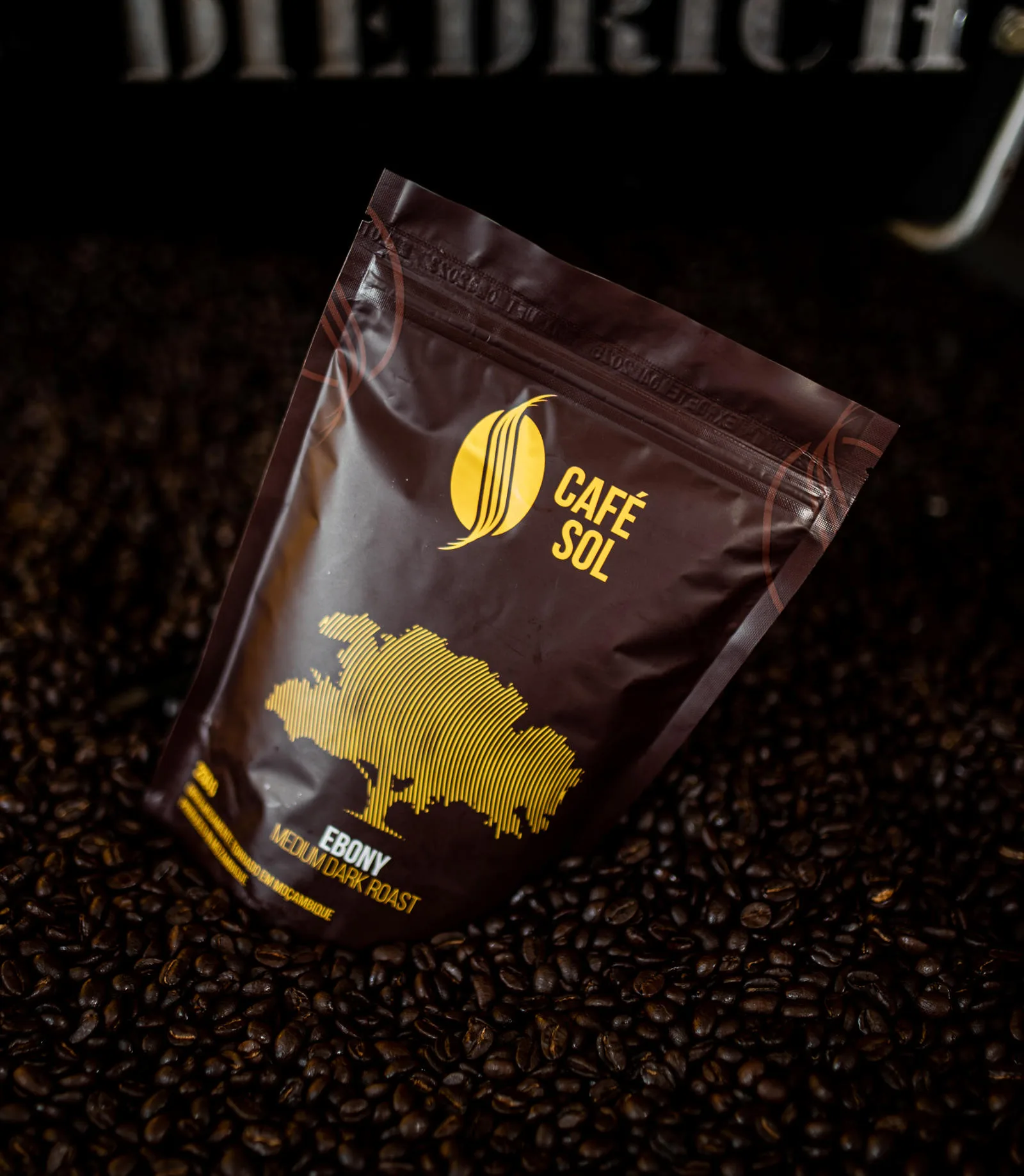 café sol ebony medium dark roast coffee package surrounded by scattered beans., café sol, são paulo