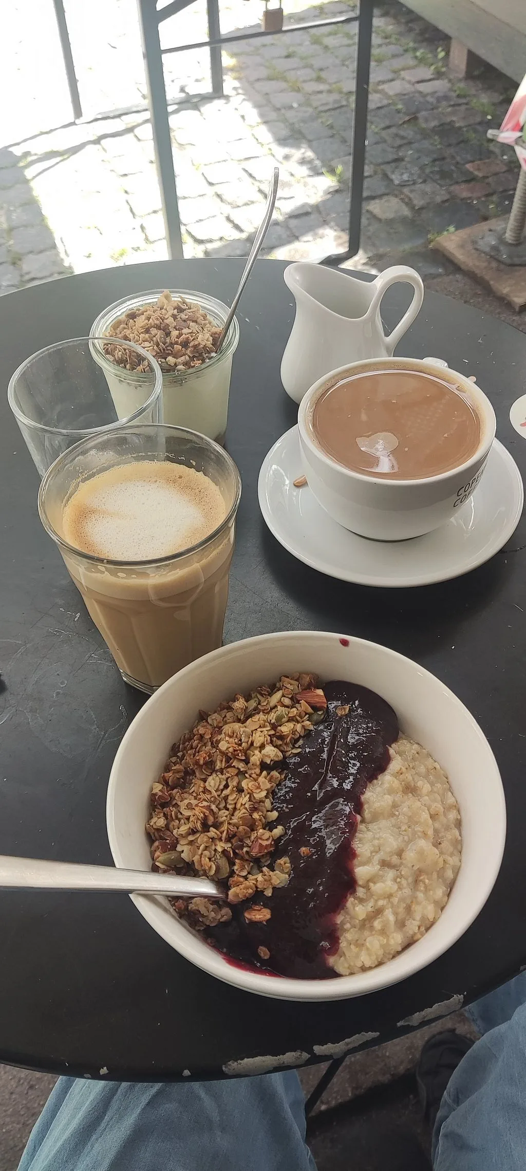 breakfast spread with granola bowl, iced coffee, hot chocolate, and yogurt parfait outdoors., café sonja, copenhagen
