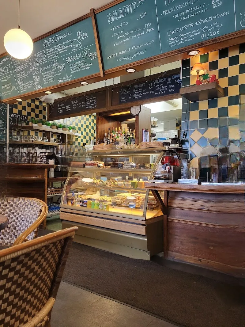 cozy café interior with checkered walls, menu boards, display case, and wooden furniture., café tin tin tango, helsinki