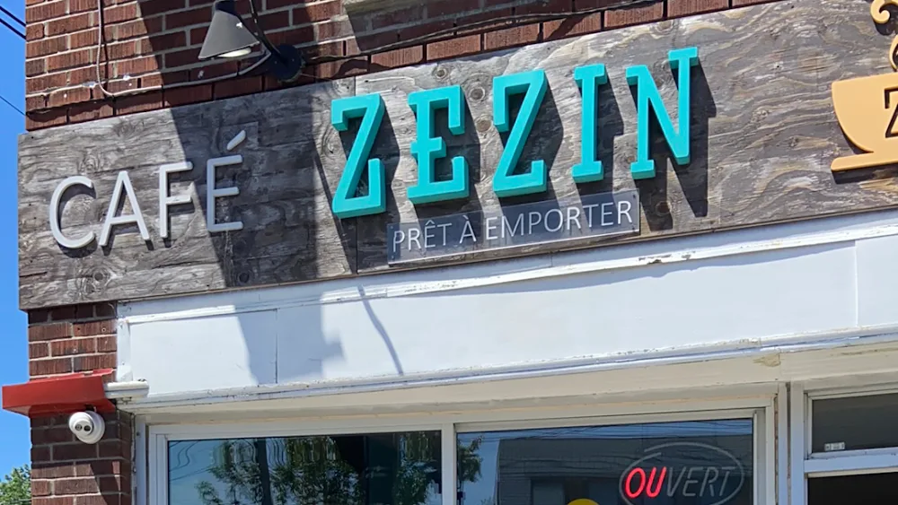 turquoise "zezin" cafe sign with "pret a emporter" text on wooden storefront., café zezin, montreal