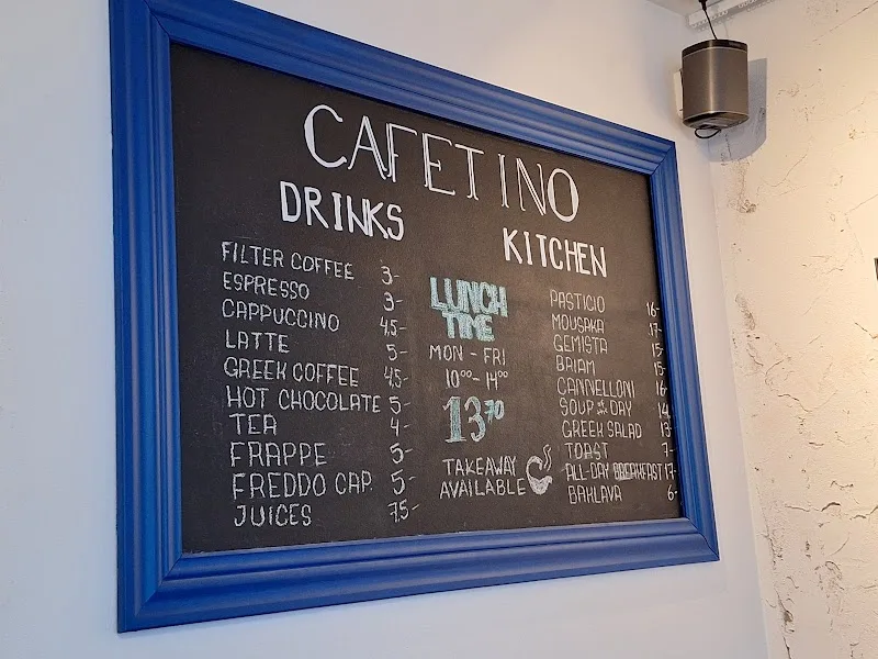 blue-framed chalkboard menu displaying café drinks and lunch offerings with prices., cafetino, helsinki