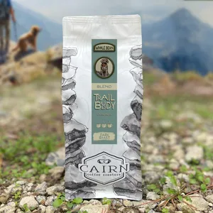 sunflower seed package displayed on rocky ground with mountain landscape background., cairn coffee roasters, concord