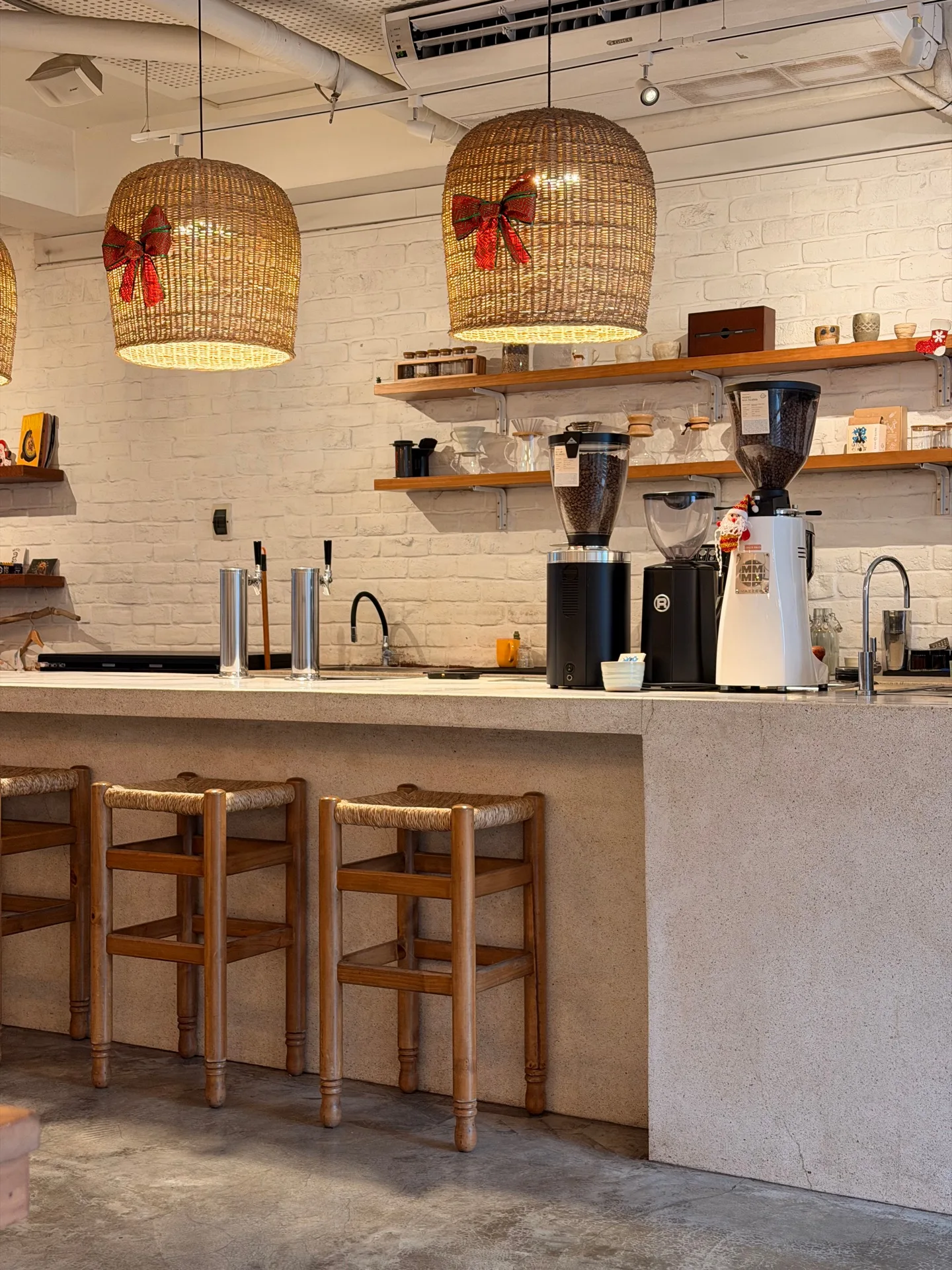modern café counter with woven pendant lights and wooden bar seating., caleta dolsa coffee, barranco