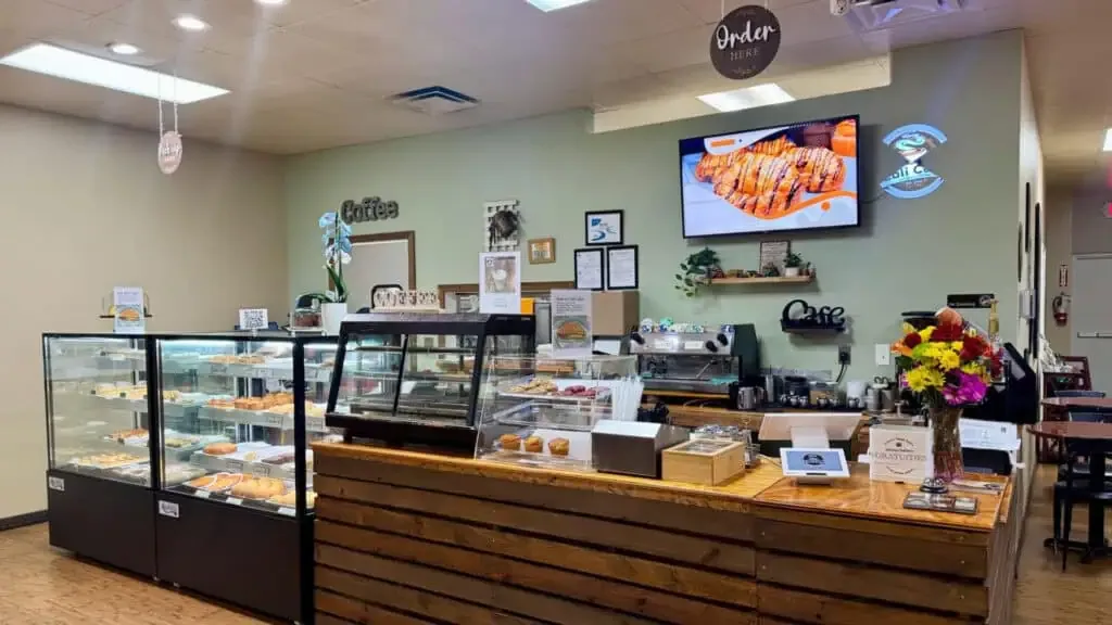 bakery café interior with display cases, pastries, counter service, and green walls., cali cafe, riverview