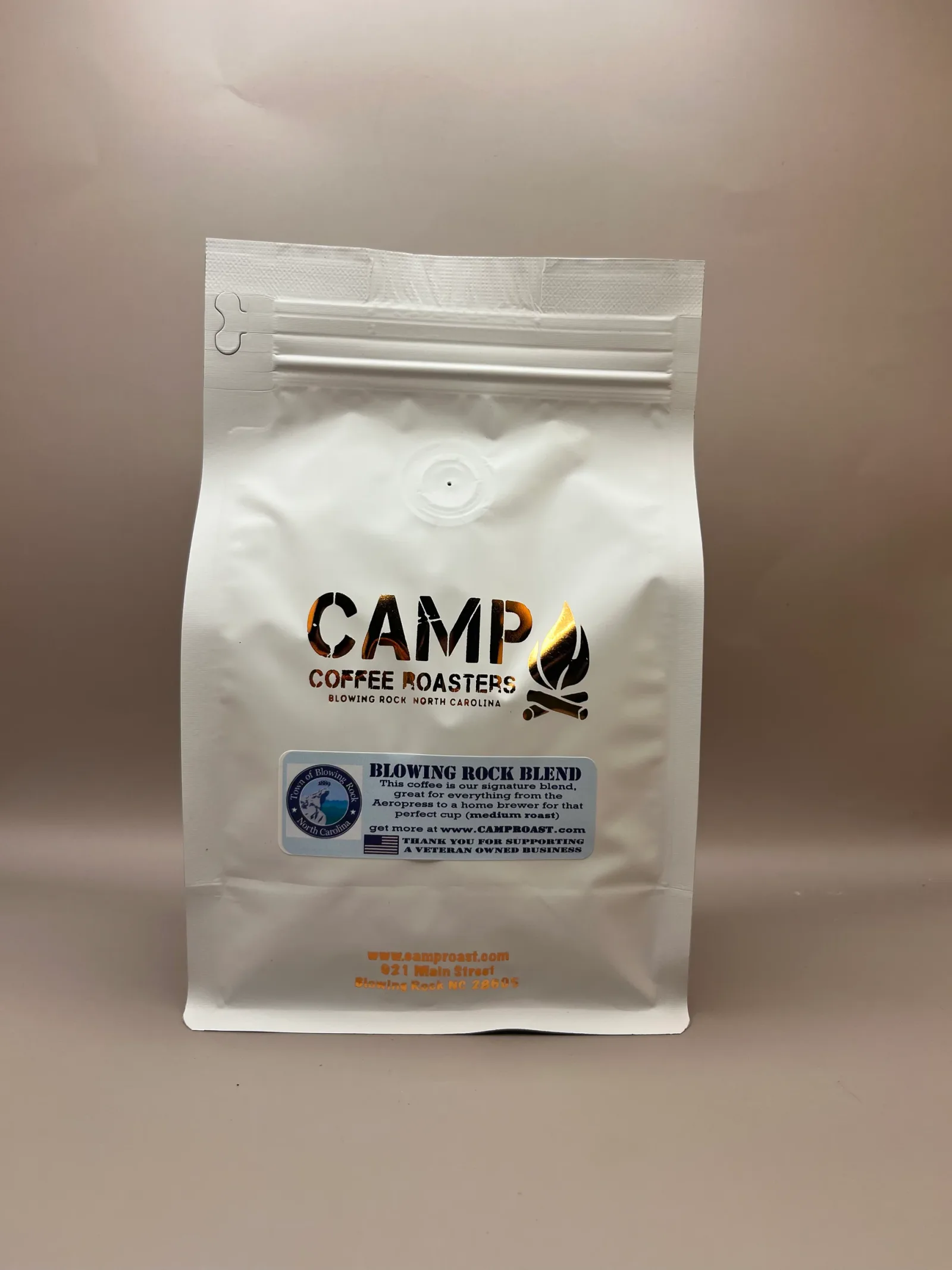 camp coffee roasters white bag with campfire logo on tan background., camp coffee roasters, blowing rock