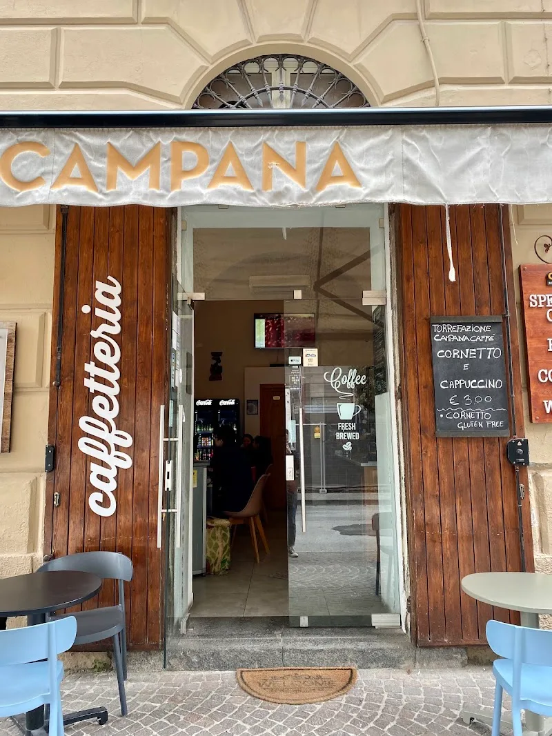 charming italian café storefront with wooden doors and awning signage., campana roastery, torre annunziata
