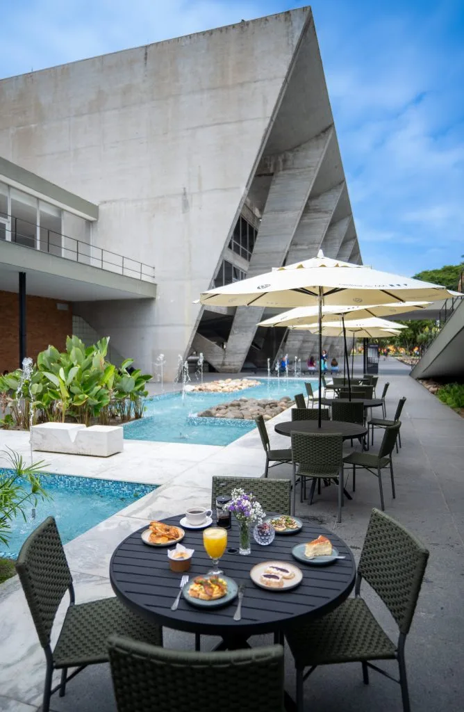 modern concrete building with poolside dining, umbrellas, and tropical landscaping., cantina do mam, rio de janeiro