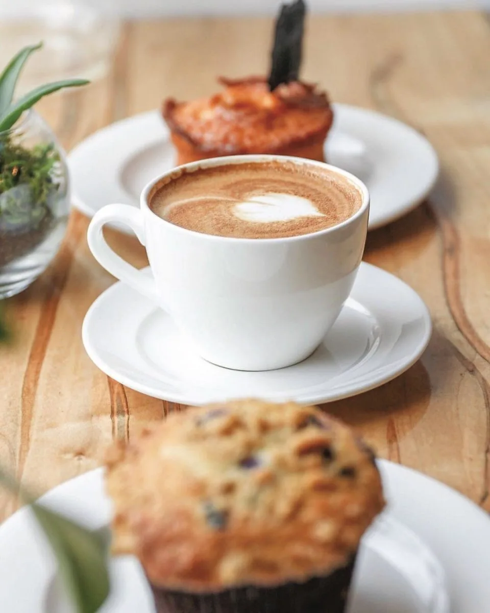 latte with latte art, pastries, and rosemary sprig on wooden table., canvas coffee, newport news