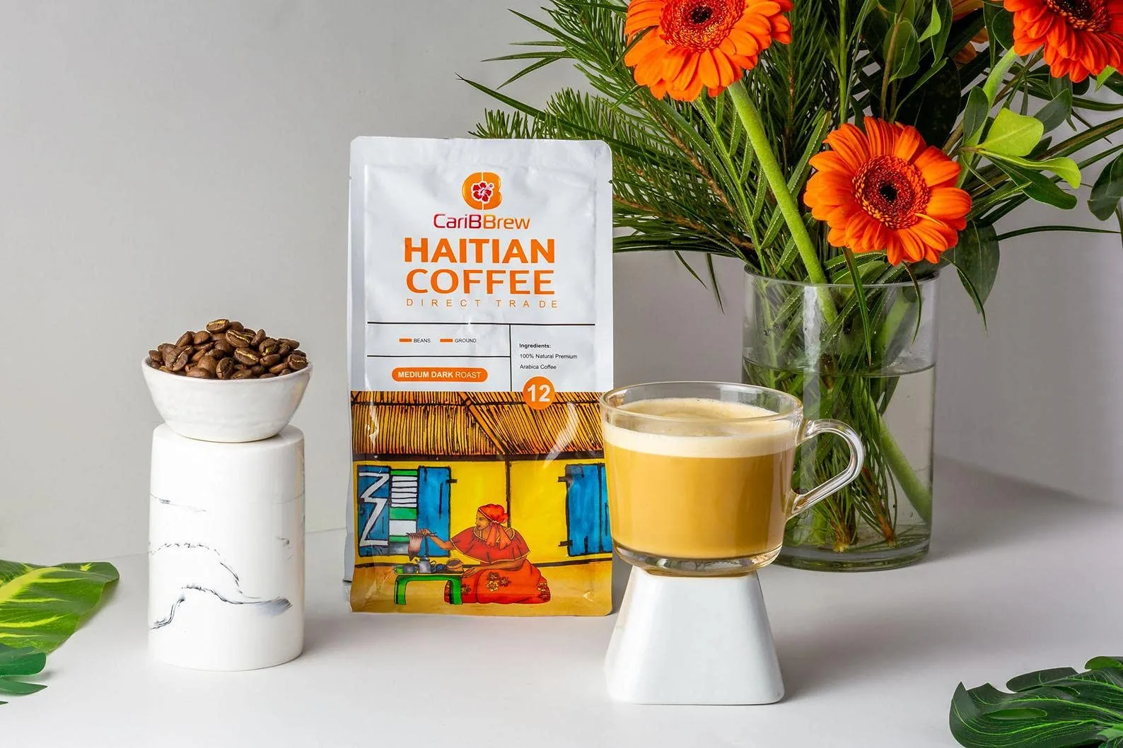 haitian coffee package, brewed cup, beans, and orange flowers on display., caribbrew, newark