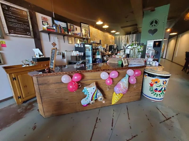 decorated wooden counter with pink balloons, ice cream cone props, and colorful trash bin., carnelian coffee co., colorado sp