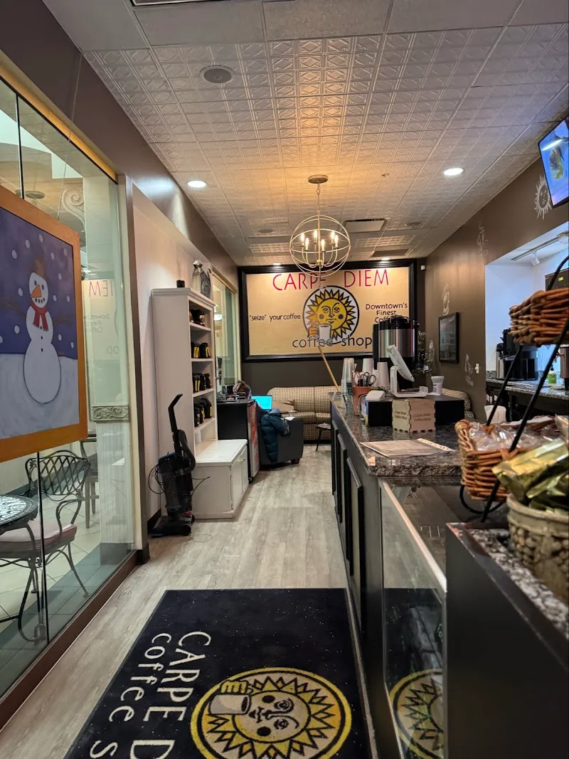 carpe diem coffee shop interior with counter, seating, and decorative sun logo signage., carpe diem coffee shop, ohio