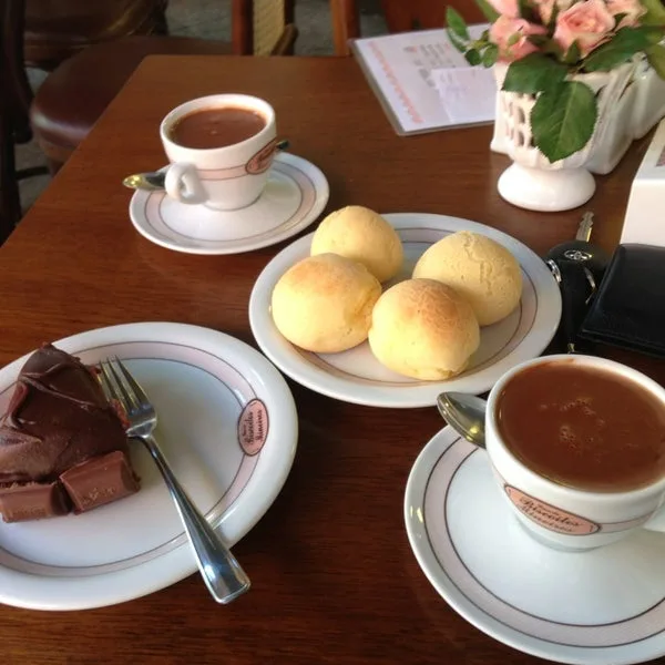 elegant table setting with pastries, chocolate cake, and two cups of tea or coffee., casa de biscoitos mineiros sudoeste, bra
