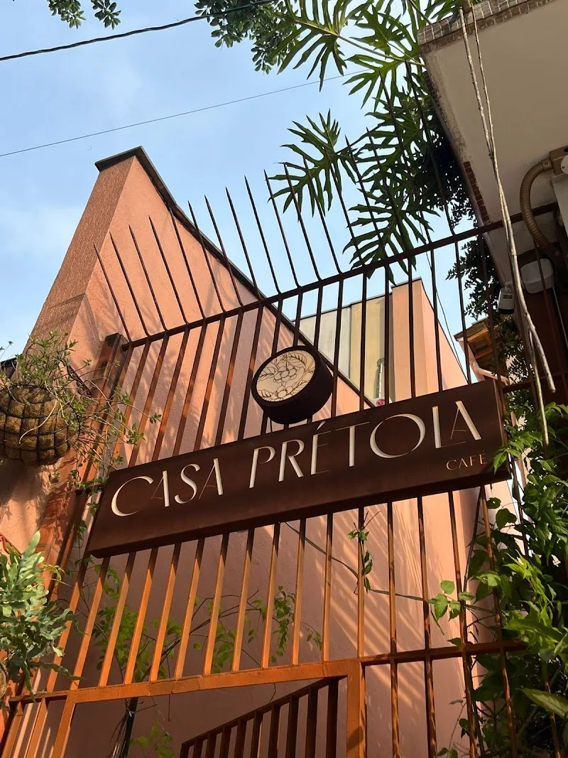 cisa pretoia cafe storefront with brick architecture and green foliage overhead., casa prétola café - cafeteria na mooca, são