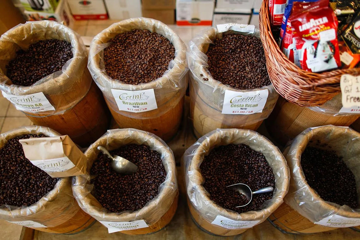 coffee beans displayed in burlap sacks with price labels at specialty shop., cerini coffee & gifts, new york