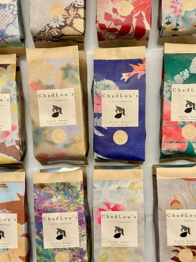 chadlou's coffee roasters packaged beans with colorful floral fabric designs displayed., chad lou's coffee, kailua