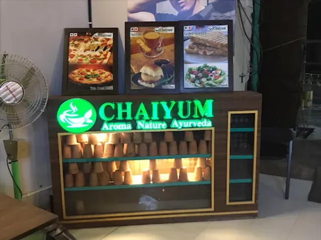 chaiyum ayurveda shop display with illuminated product shelves and food menu boards above., chaiyum, gurugram
