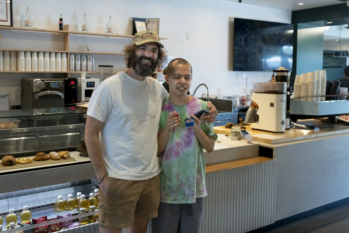 two people smiling in a modern bakery cafe with pastries and product displays., chase coffee roasters, fullerton