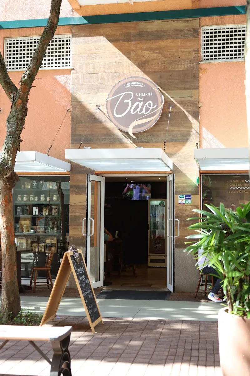 storefront entrance with "cheirín bão" circular sign and wooden facade., cheirin bão, rio de janeiro