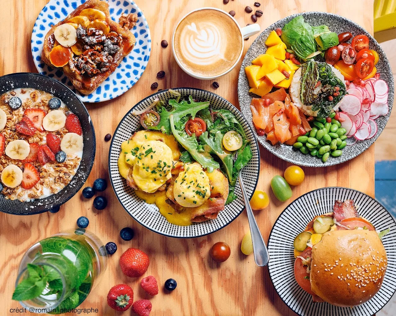colorful brunch spread with cereals, eggs, toast, salads, and coffee on wooden table., clint gare de lyon, paris