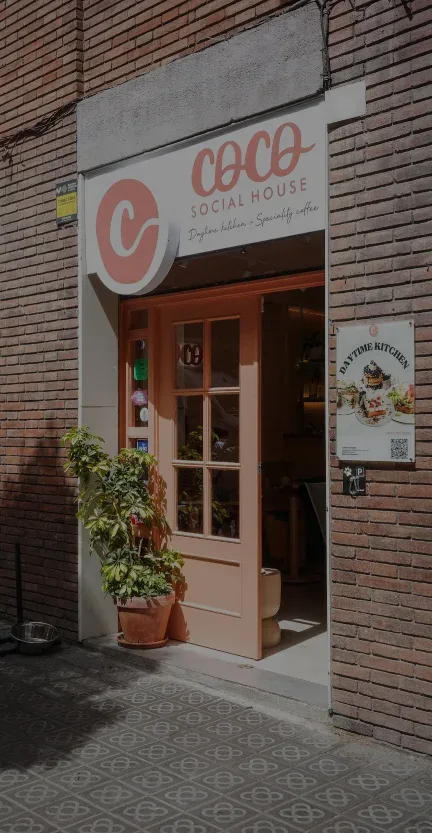 coco social house storefront with red door and brick facade entrance., coco social house - valència, valència