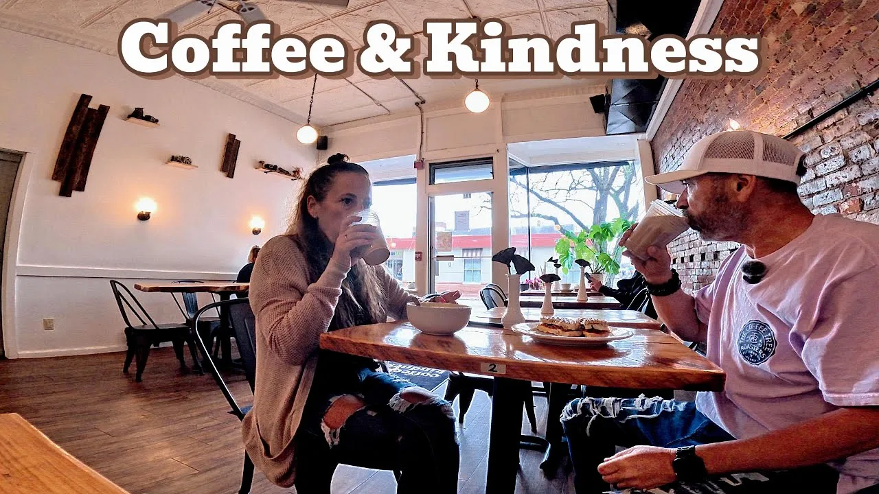two people sharing coffee and conversation at a wooden table in a cozy café., coffee and kindness, nashua