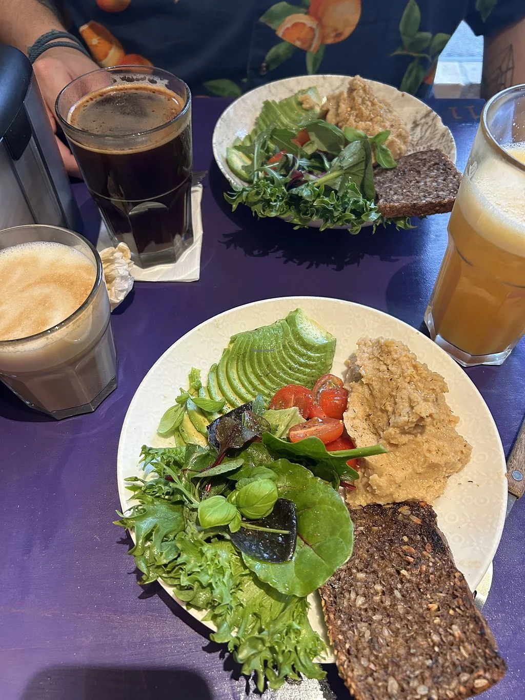 healthy brunch plates with avocado, greens, whole grain bread, and beverages., coffee fellaz, copenhagen