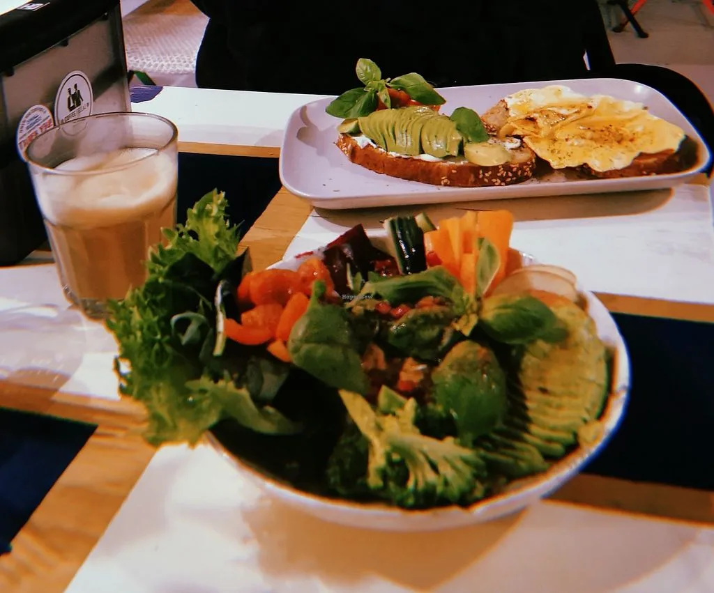 restaurant meal with avocado toast, salad, and beverage on wooden table., coffee fellaz, copenhagen
