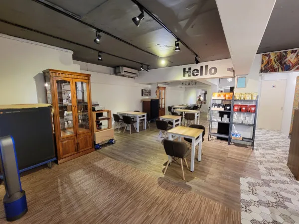 bright, modern classroom or studio space with wooden furniture and "hello" sign., 珈啡所在 coffee field, taipei