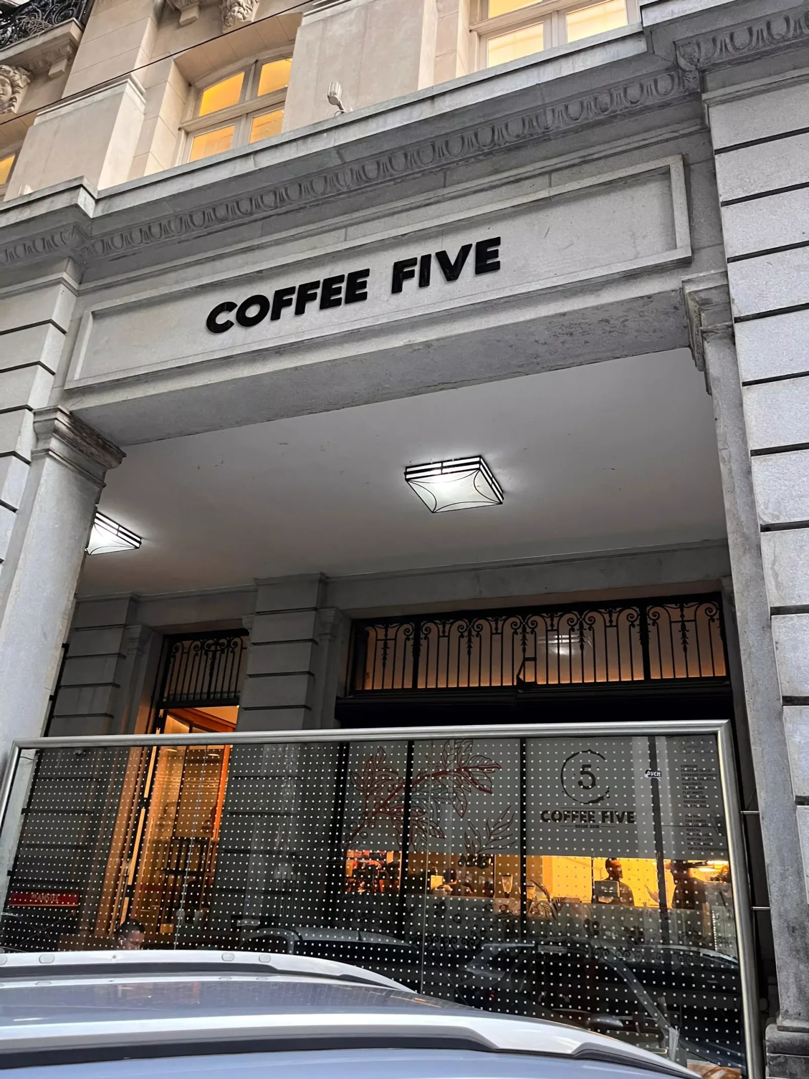 coffee five storefront with perforated metal facade and illuminated interior signage., coffee five, rio de janeiro