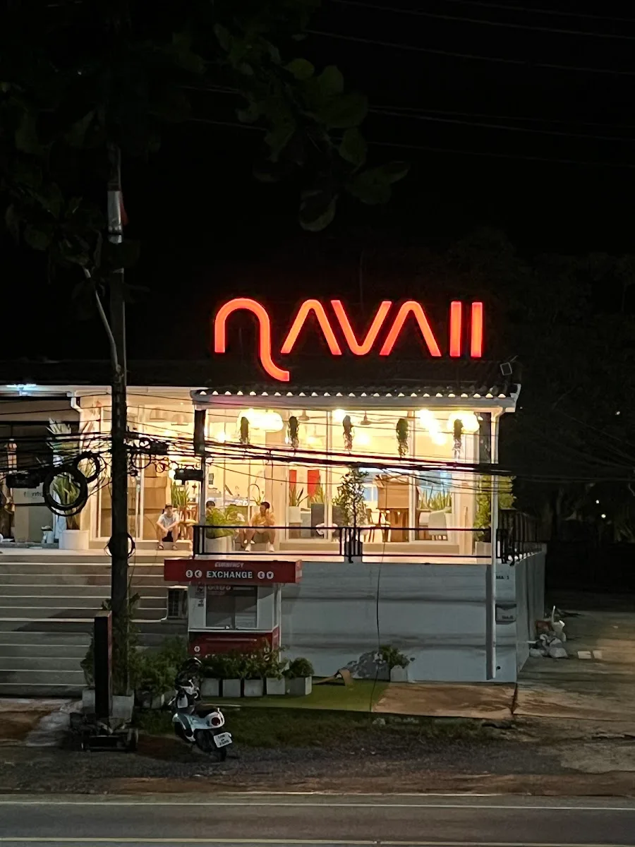 neon-lit storefront at night with glowing orange sign and interior lighting visible through windows., coffee near me.patong x
