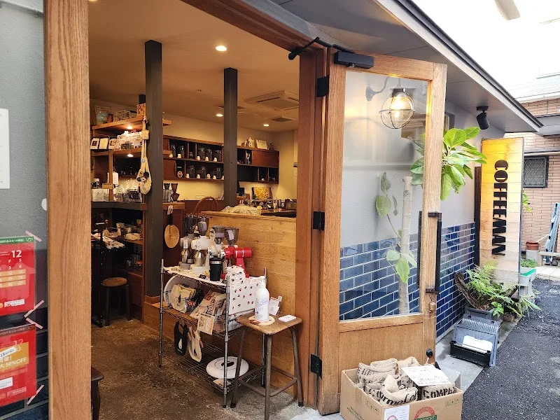 small wooden storefront shop with shelving, plants, and merchandise display., coffeeman, fukuoka