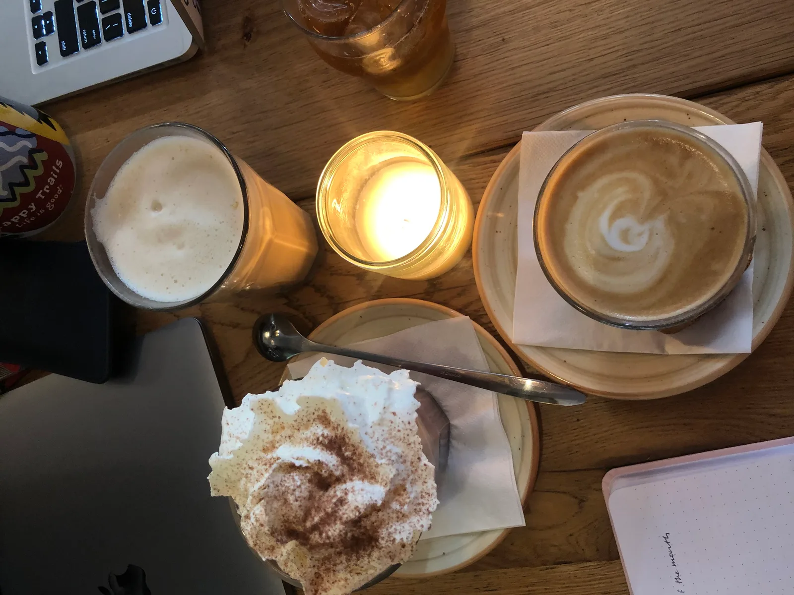 coffee drinks and pastry arranged on wooden table with laptop and notebook., coffeenhagen, copenhagen