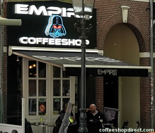 empire coffeeshop storefront with darth vader logo and neon signage at night., coffeeshop empire, haarlem