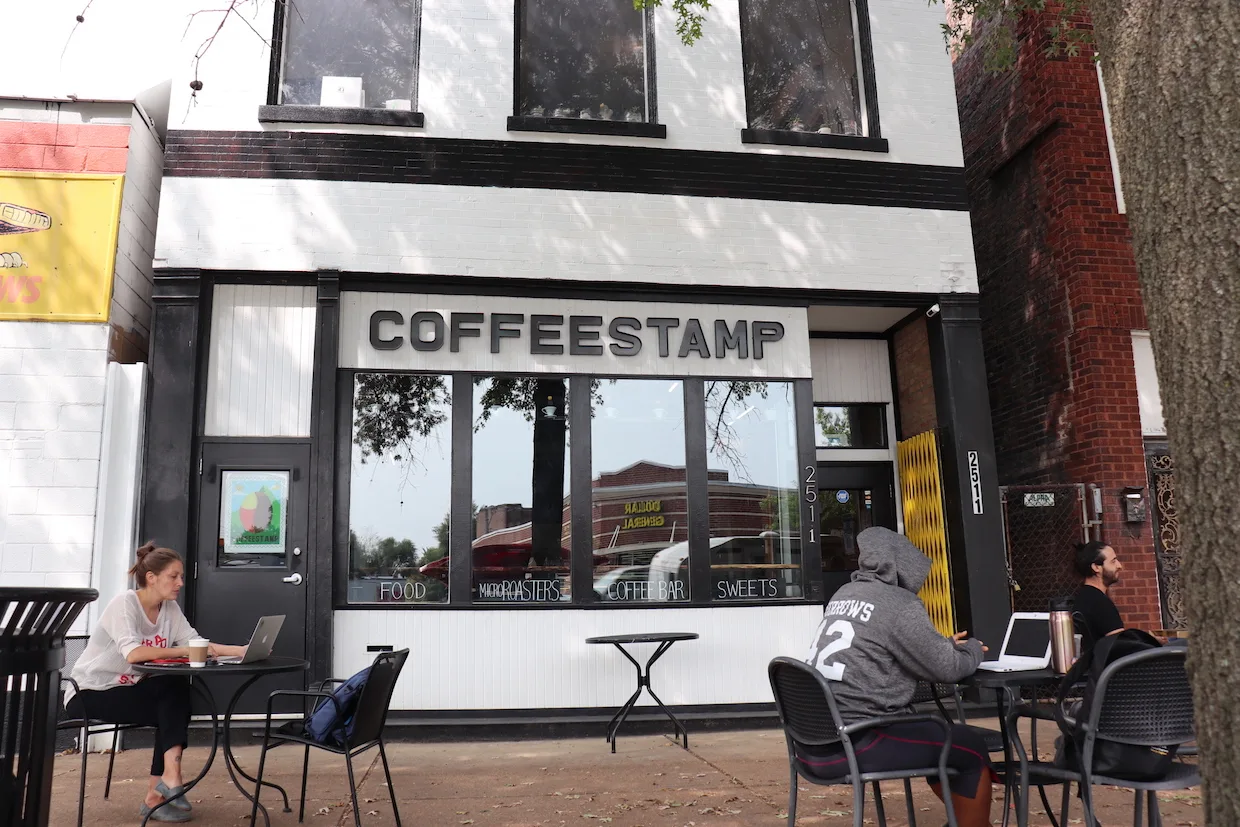coffeestamp storefront with outdoor seating and customers working on laptops., coffeestamp, st. louis