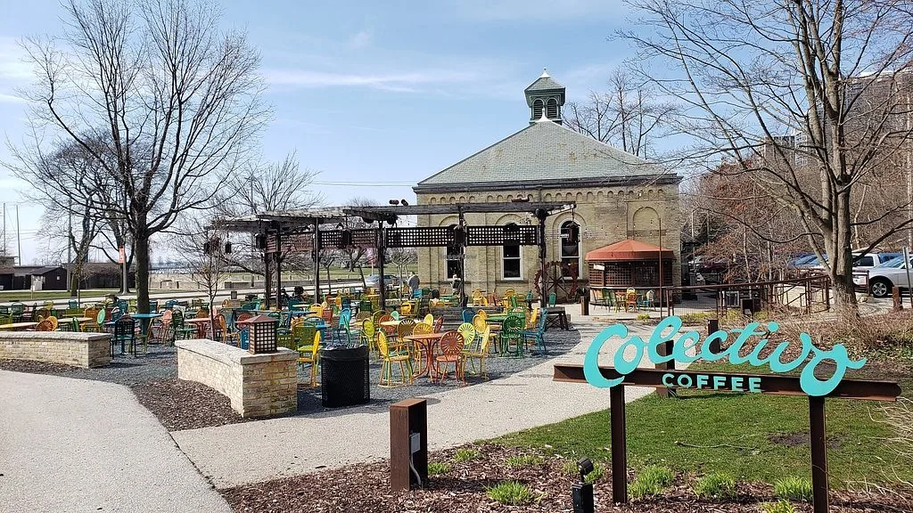 outdoor coffee seating area with historic domed building and colorful chairs., colectivo coffee on the lakefront, milwaukee