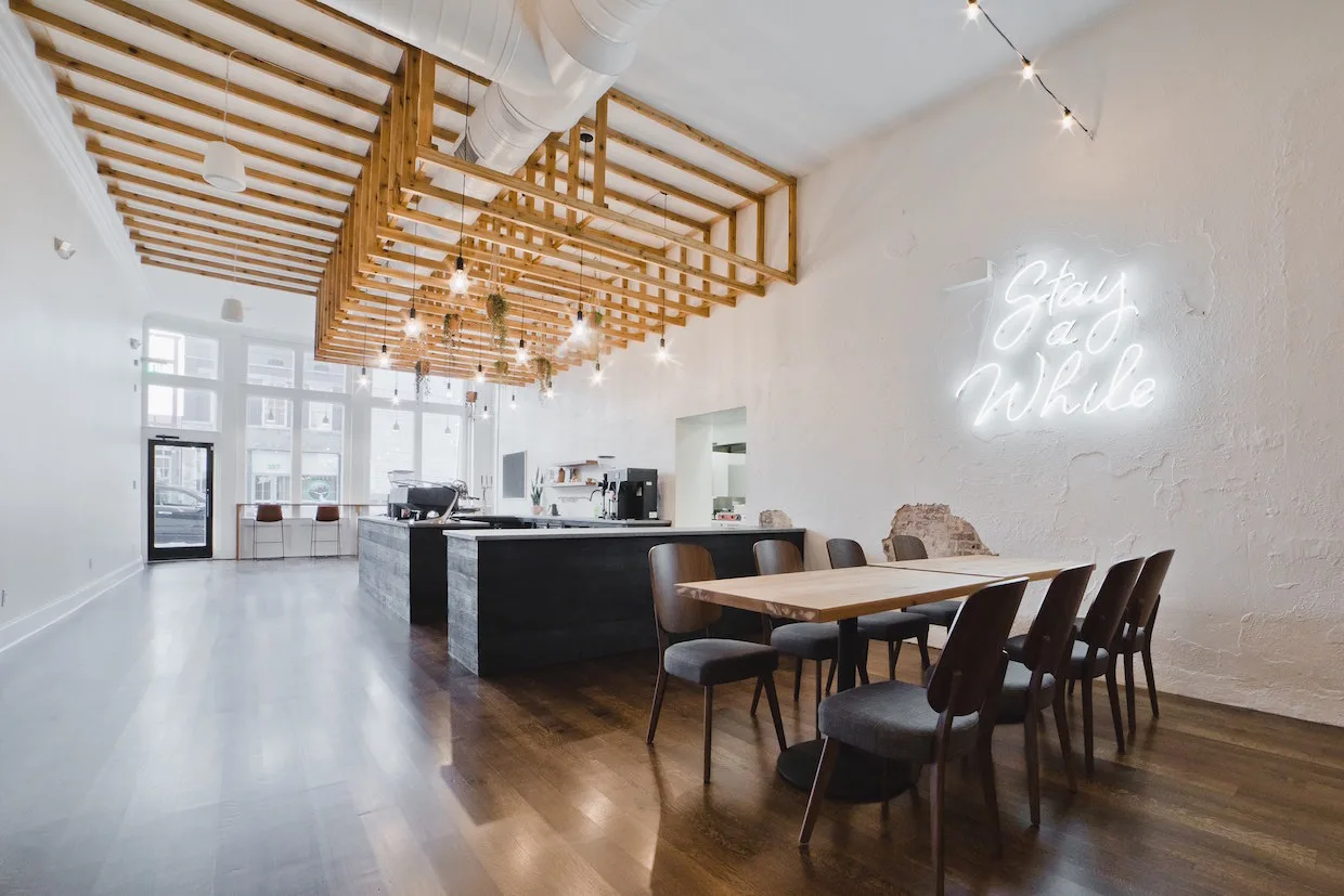 modern office space with wooden lattice ceiling, dining table, and neon sign., comeback coffee, memphis