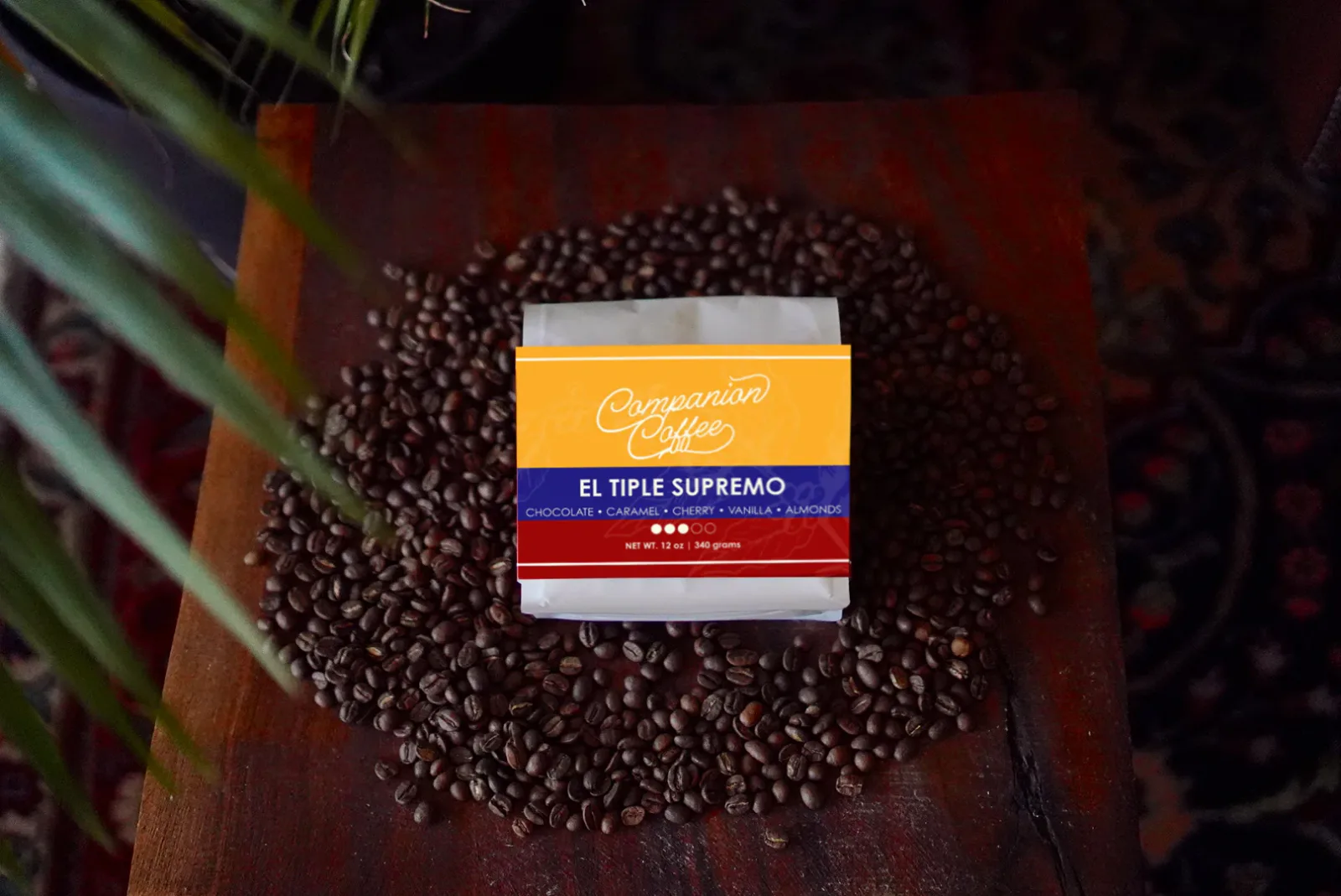 companion coffee el triple supremo package surrounded by coffee beans on wooden surface., companion coffee roasters, florence