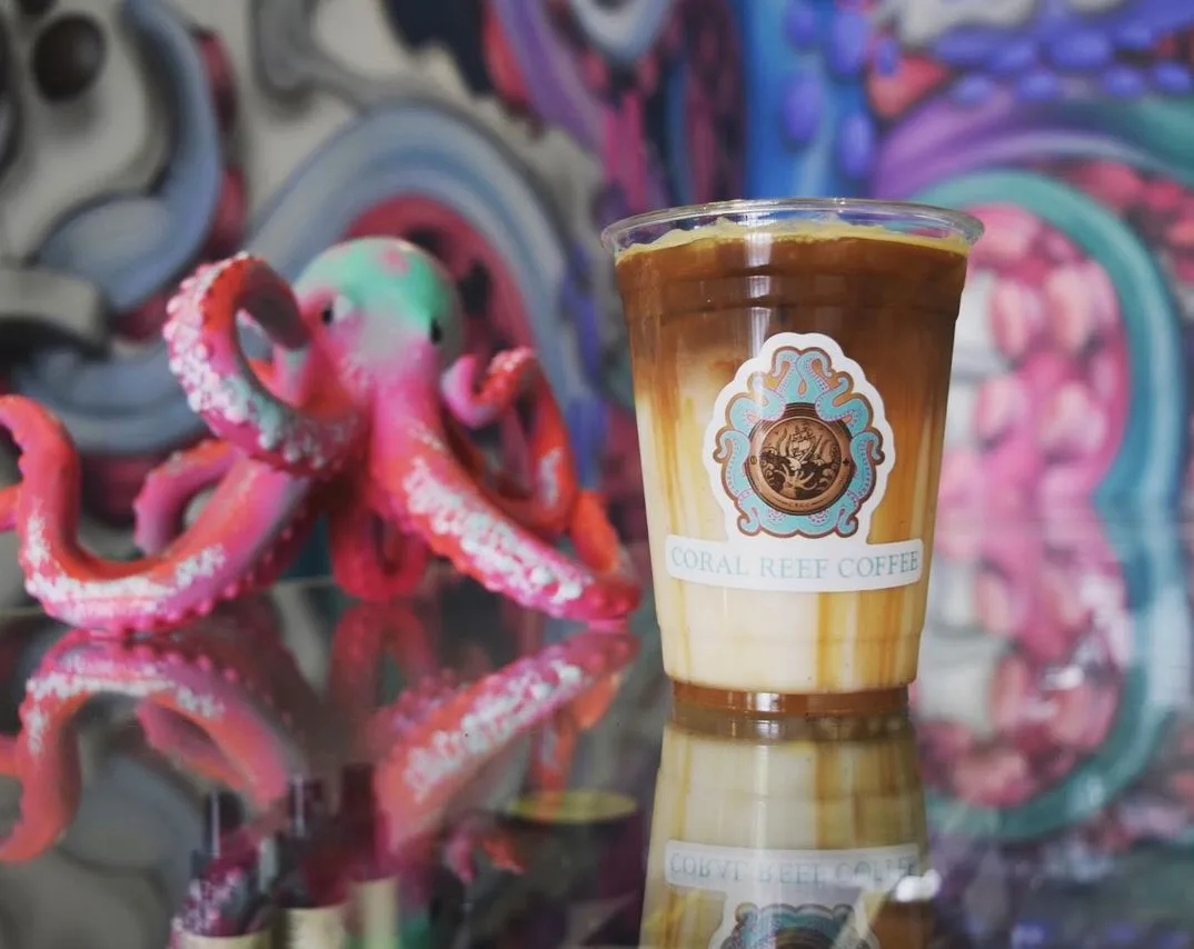 coral reef coffee drink with colorful octopus art backdrop and reflection., coral reef coffee company, lewisville