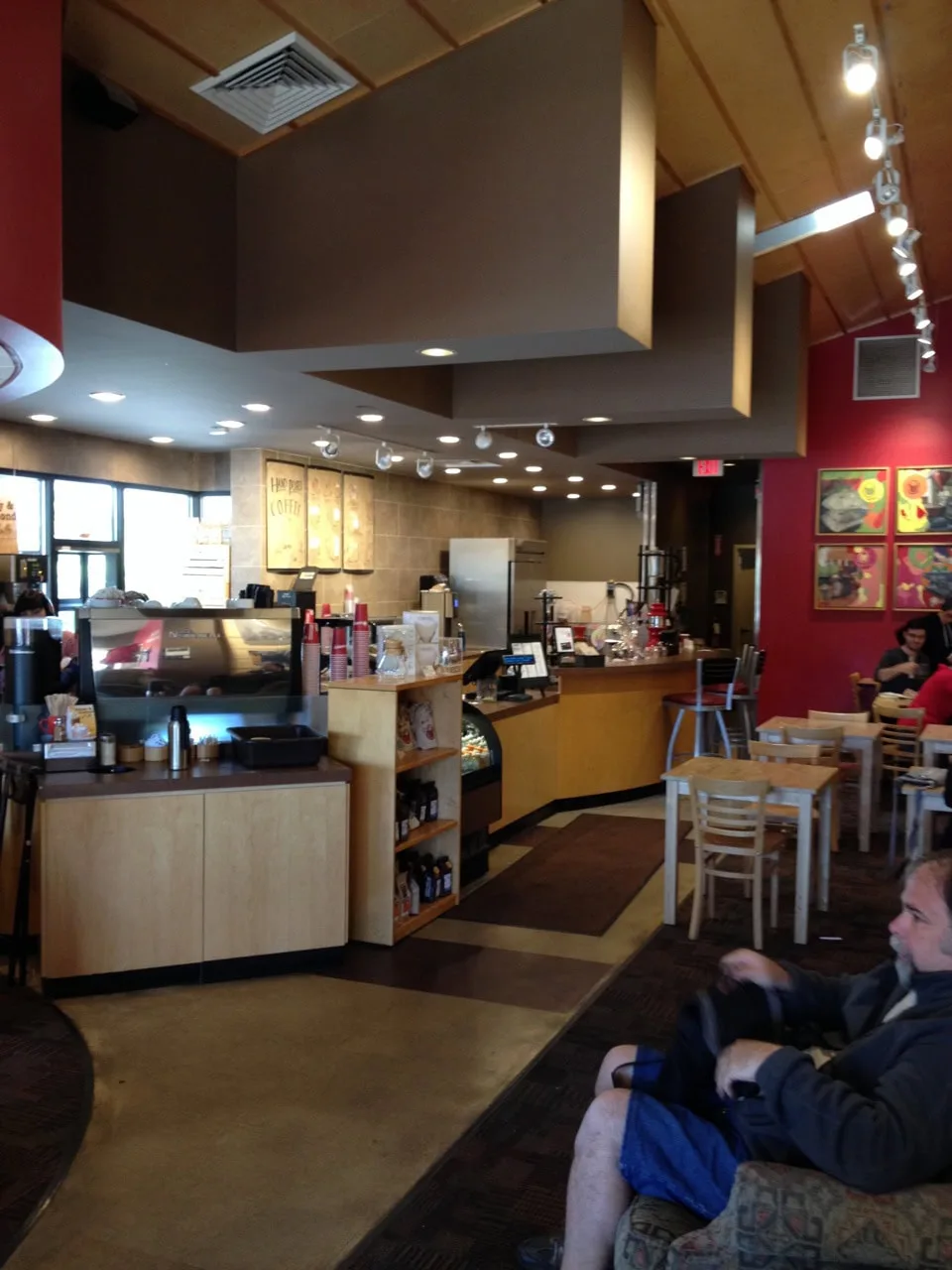 modern coffee shop interior with counter, seating area, and warm lighting design., crimson cup coffee shop - clintonville, co