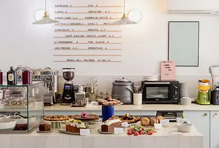 kitchen counter cluttered with appliances, ingredients, and cooking equipment displayed together., culottée boétie - petit dé