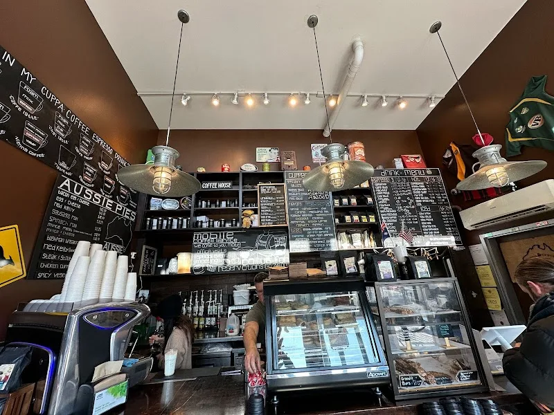 coffee shop counter with menu boards, pastry display, and pendant lighting., cuppacoffee, boston