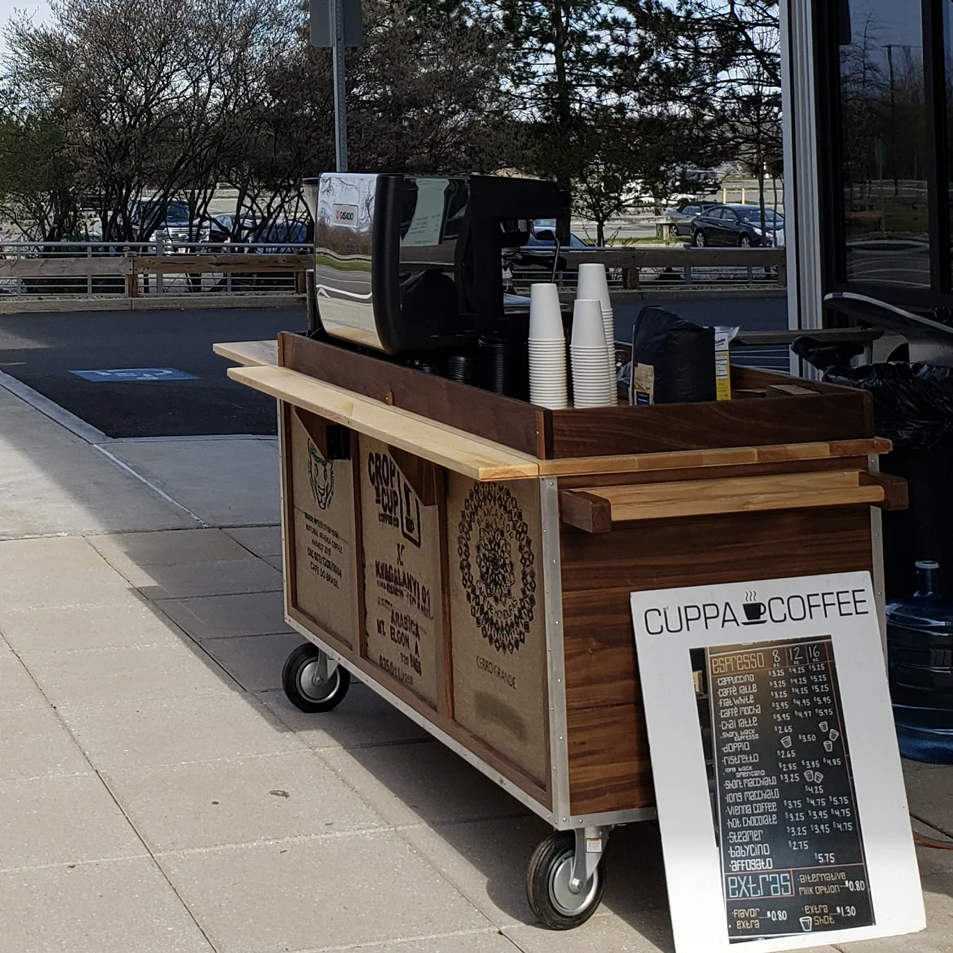 mobile coffee cart with menu board, cups, and espresso machine on sidewalk., cuppacoffee, boston