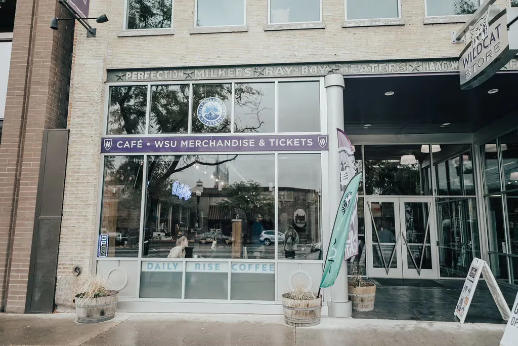 storefront café with wsu merchandise, tickets, and daily rise coffee signage., daily rise coffee downtown, ogden